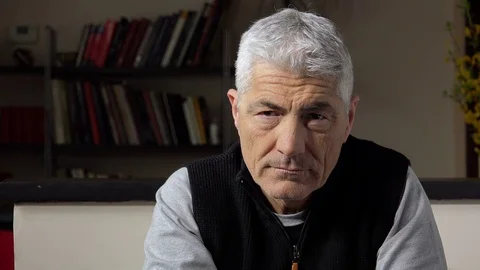Sad depressed mid aged man looking in the camera with worried gaze Vídeo Stock 74683669