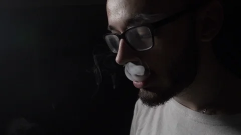 Sad depressed young IT engineer boy with glasses performing vaping tricks in  Video stock 87730654