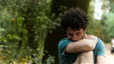 Sad depressed young man alone in the park Stock-Footage 78287436
