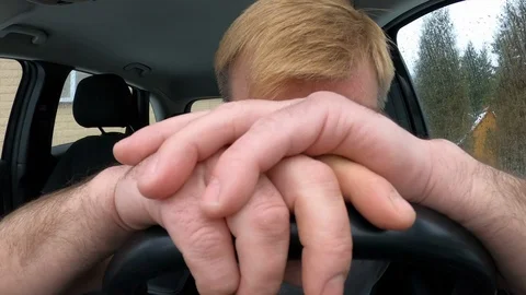 Sad desperate man crying in a car while sitting at the wheel Stock Footage 126542549