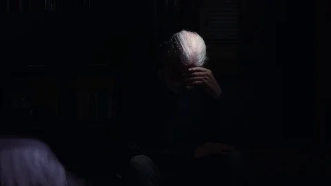 Sad Desperate old man sitting on the bed in the dark,portrait 스톡 동영상 74981576