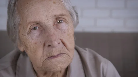 Sad elderly woman looking into the camera. Stock Footage 103229717