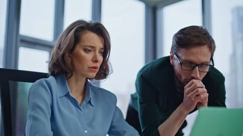 Sad employees disappointed mistake project looking laptop at workplace closeup. Stock Footage 340528187