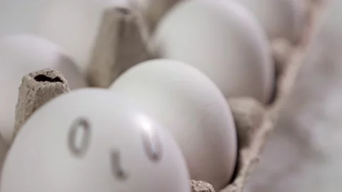 Sad face drawn on white egg with black marker at home Stock Footage 221844971