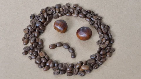 A Sad face made up of coffee beans and chestnuts. Stock Footage 96393037