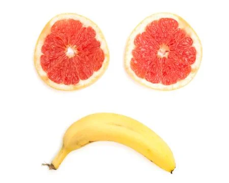 Sad face made from grapefruit and banana on white background Foto stock