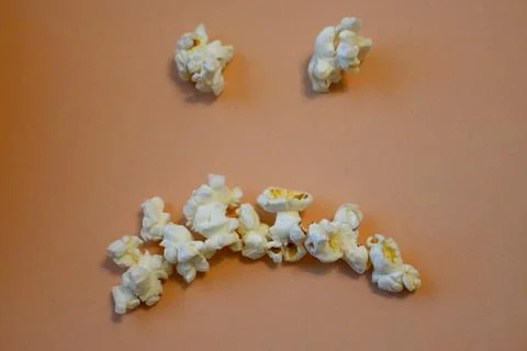 Sad face made from popcorn Stock Photos