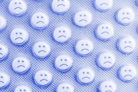 Sad face of pills Stock Photos