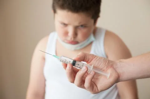 Sad fat boy is afraid of injection 스톡 사진