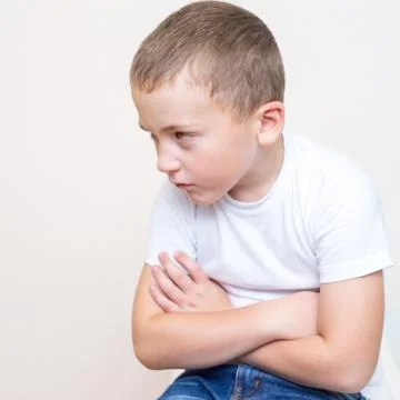 Sad five year old boy on a white backround Stock Photos