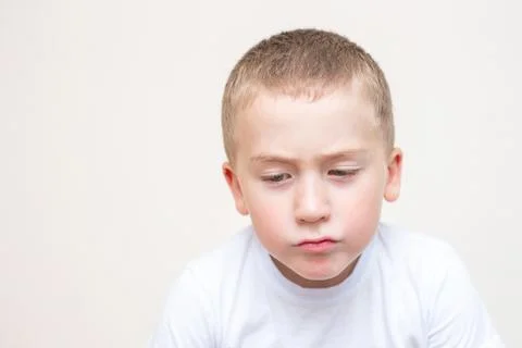 Sad five year old boy on a white backround Stock Photos