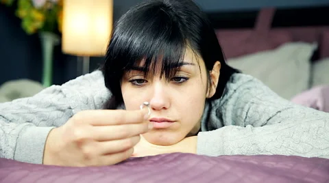 Sad girl in bed thinking about engagement looking ring Stock Footage 49221781