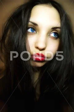 Sad girl with dark blue eyes Stock Photos