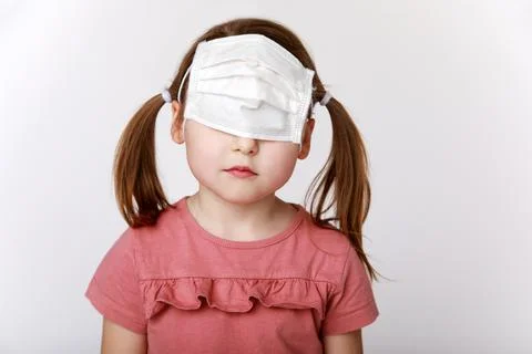 Sad girl with a medical mask on her eyes Stock Photos
