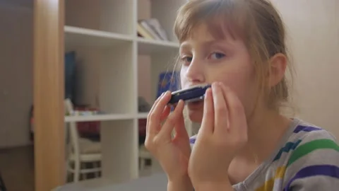 Sad Girl Playing Harmonica Stock Footage 147947560