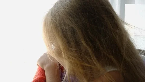 Sad girl by the window Stock Footage 124835408
