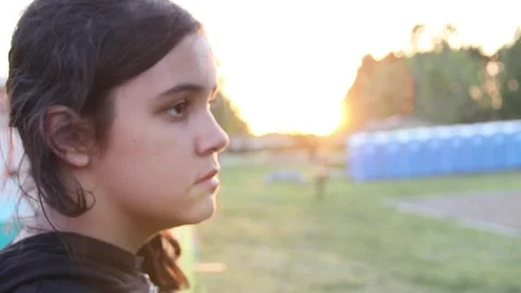 Sad girl's face with sun setting Stock Footage 154992564