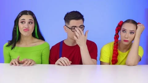 A sad group of friends are sitting at a table at a party Stock Footage 166884807