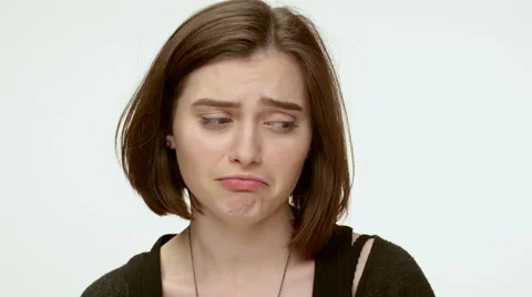Sad grumpy girl on a white background. Close up Stock Footage 64120739