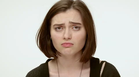 Sad grumpy girl on a white background. Close up Stock Footage 64120968
