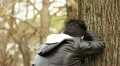 Sad guy at park strikes the tree with a punch HD Footage