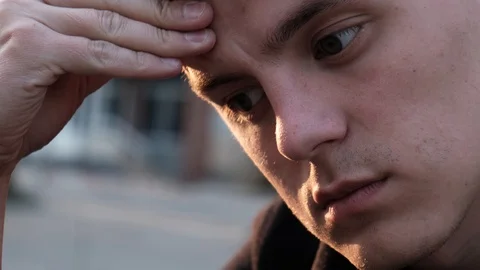 Sad guy scratching his forehead and doesn’t know what to do Video stock 106958613