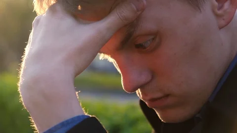 Sad guy scratching his forehead and doesn’t know what to do Video stock 112601956