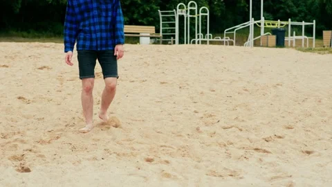 A sad guy walks along the beach and falls to his knees Stock Footage 196147822