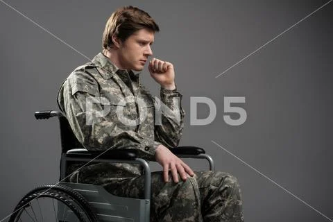 Sad handicapped military man suffering from loneliness Stock Photos