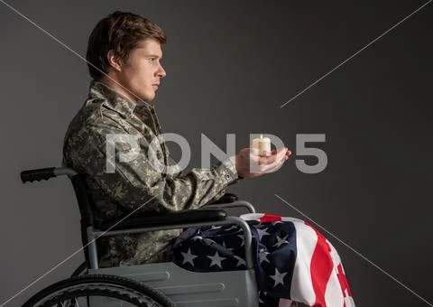 Sad handicapped veteran having candle in his hands Stock Photos