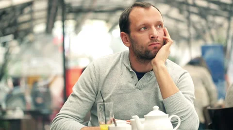 Sad, handsome man sitting alone in the cafe Stock Footage 36644848