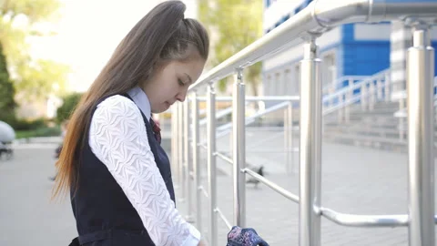 Sad high school girl returns home from school. Schoolgirl teenager throws the Stock Footage