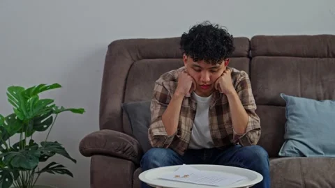 Sad husband grieving failed marriage with divorce decree and rings in Видео 331494040