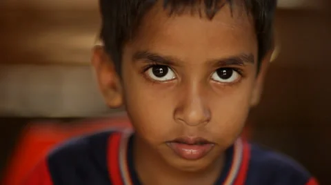 Sad Indian boy looking into camera with ... | Stock Video | Pond5