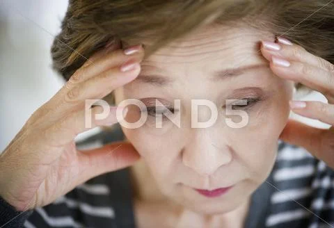 Sad Japanese Woman With Head In Hands