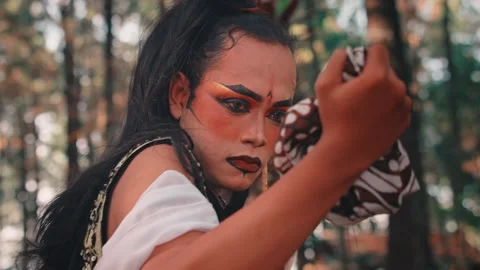 A Sad Javanese Man Wringing a Batik Handkerchief Stock Footage 313472743