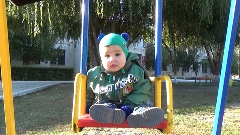 Sad kid on a swing Stock Footage 85827427