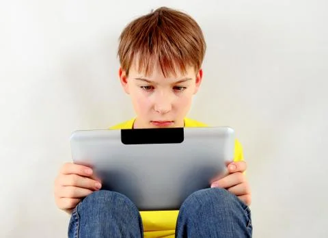 Sad Kid with Tablet Foto stock