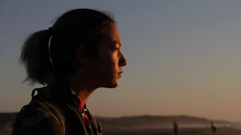 Sad kid watches sun set Stock Footage 123200004