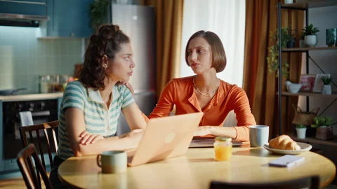 Sad ladies worried problem sitting kitchen with laptops closeup. Upset brunette Stock Footage 333793004