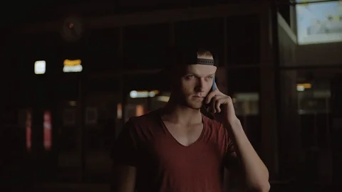 Sad likable guy talking on smartphone. Young Caucasian man breaking up with Stock Footage 91154938