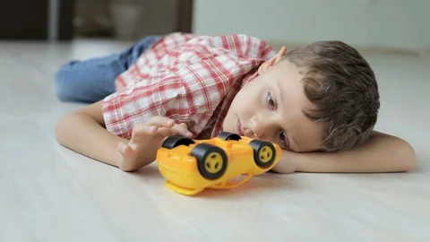 Sad little boy lying on the floor at home   Stock Footage 88549401