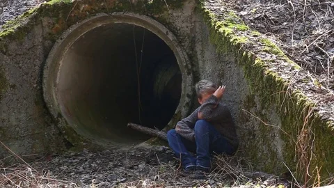 Sad little child hiding from people in abandoned ruins Stock Footage