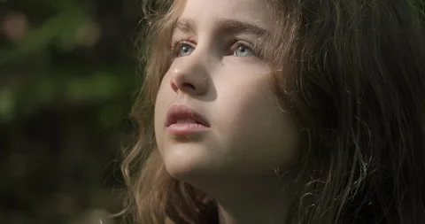 Sad Lonely Child Looking Up at Sky in Nature. Portrait .. Stock Footage 340629754