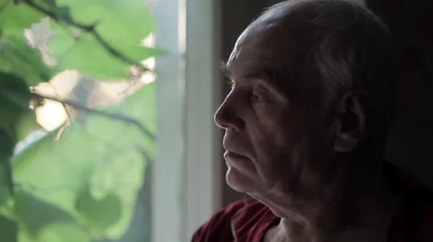Sad Lonely Elderly Old Man Looking Out Window At Sunset HD Stock Footage