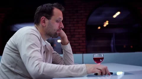 Sad lonely man drinking wine in bar HD Video stock 10743050