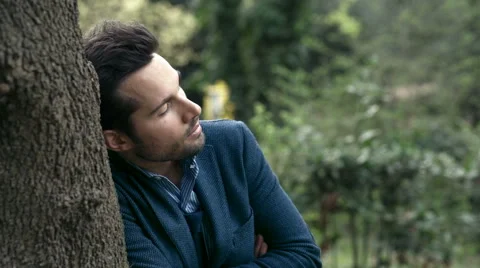 Sad man alone in the park while waiting for his girlfriend Stock Footage 64722498