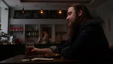 Sad man in a cafe drinking beer Stock Footage 223884015