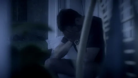 Sad man crying alone late at night Stock Footage 287420919