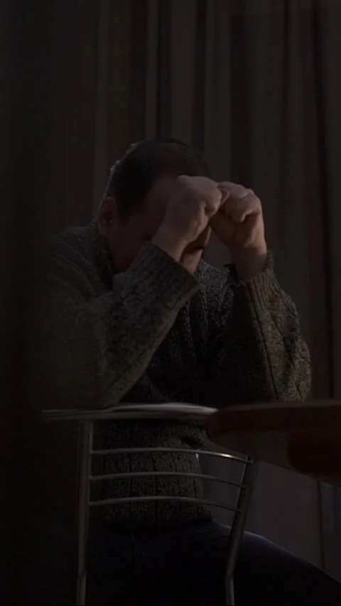A sad man during a crisis. Concepts of depression, illness, and tragedy. Video stock 327851047